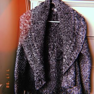 Knitted poncho with sleeves.